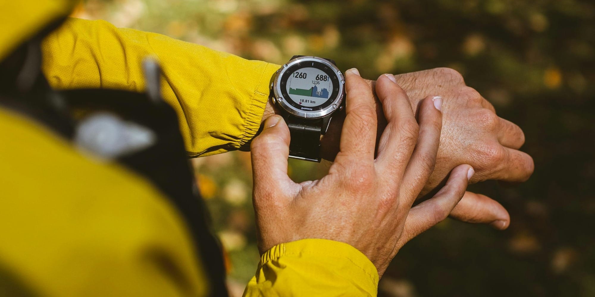a man in a yellow jacket holding a compass
